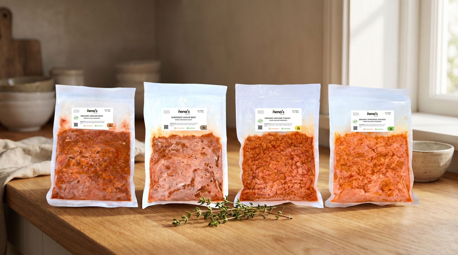 Nena's Kitchen homepage hero — the 4 organic proteins lineup on a warm wooden counter
